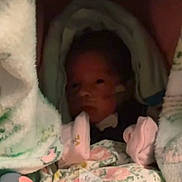 Zyalani joined the competition — help win amazing prizes! baby, newborn, blanket, mittens, infant, face, swaddled, hospital, medical_tube, pink, soft, sleeping, cute, child, person, indoors, closeup, warm, cozy, resting