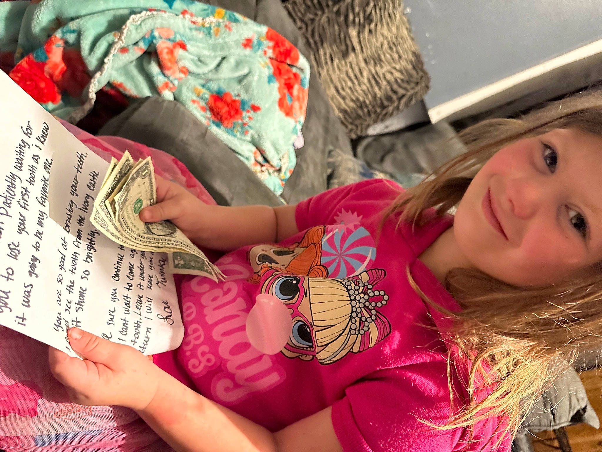 Nova is registered to the contest to win money with this photo: abdomen, child, flesh, font, fun, hand, handwriting, happy, headwear, human, human_leg, joy, linens, magenta, nail, pattern, person, pink, sleeve, smile