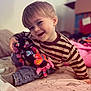 Grayson joined the competition — help win amazing prizes! toddler, child, smiling, striped_sweater, stuffed_toy, butterfly_pattern, bed, blanket, indoor, happy, person, jeans, sock, toy, cozy, home, cute, playful, portrait, casual