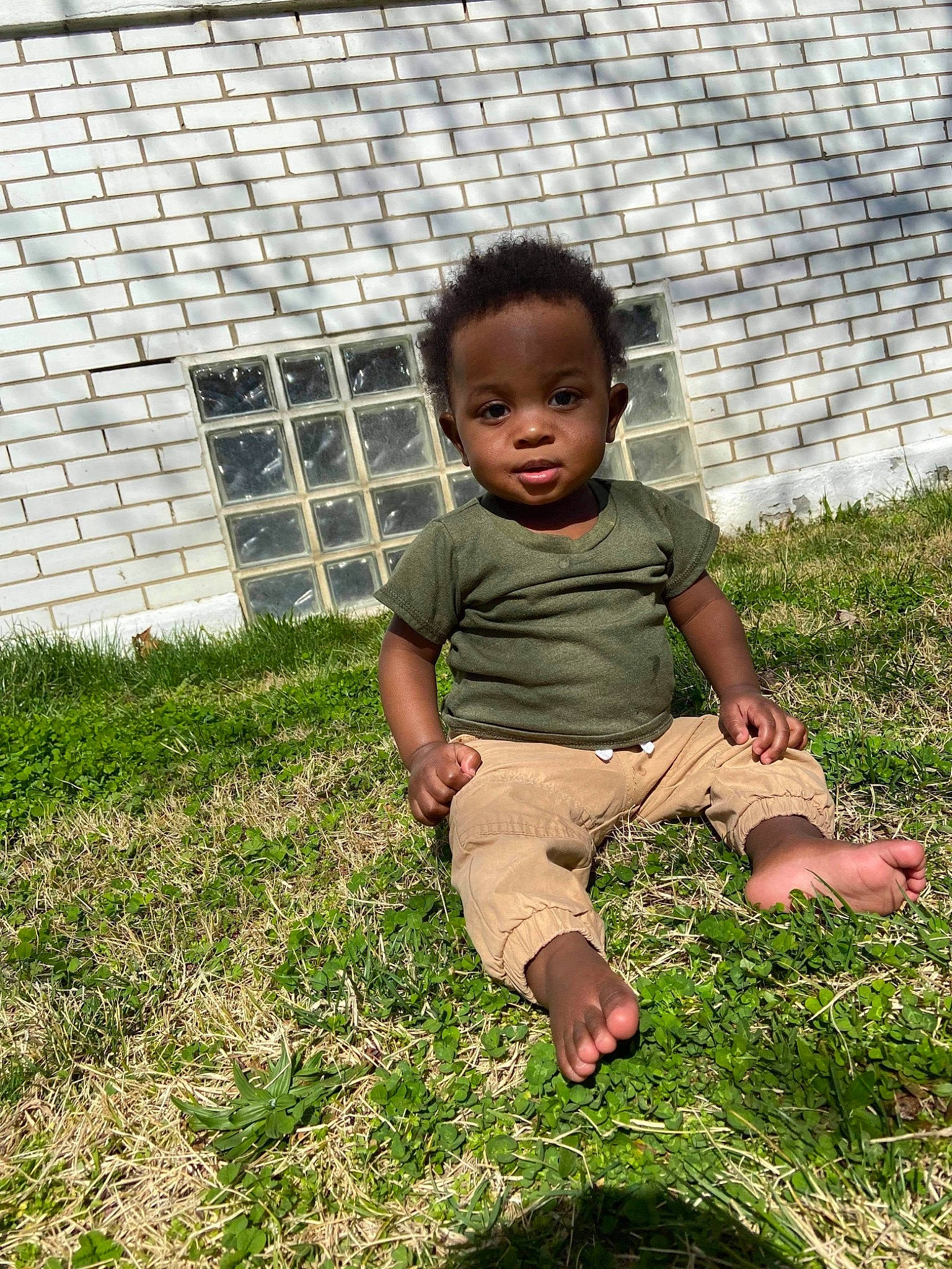 Dasan joined the competition — help win amazing prizes! baby, baby_toddler_clothing, barefoot, child, fence, foot, garden, grass, grassland, groundcover, happy, human_leg, lawn, mesh, people_in_nature, person, plant, sitting, sleeve, t_shirt