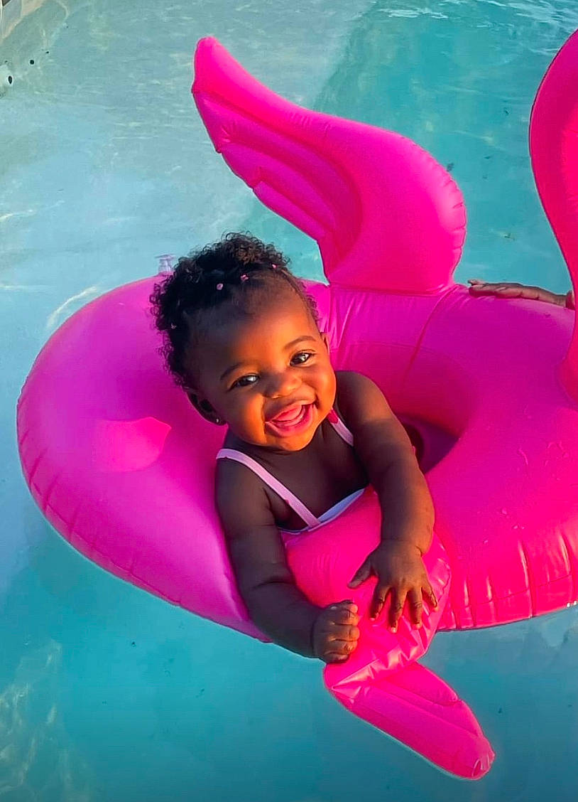 Rihanna joined the competition — help win amazing prizes! azure, child, facial_expression, flash_photography, fun, games, gesture, happy, inflatable, leisure, magenta, people_in_nature, person, pink, play, recreation, smile, summer, swimming_pool, toddler