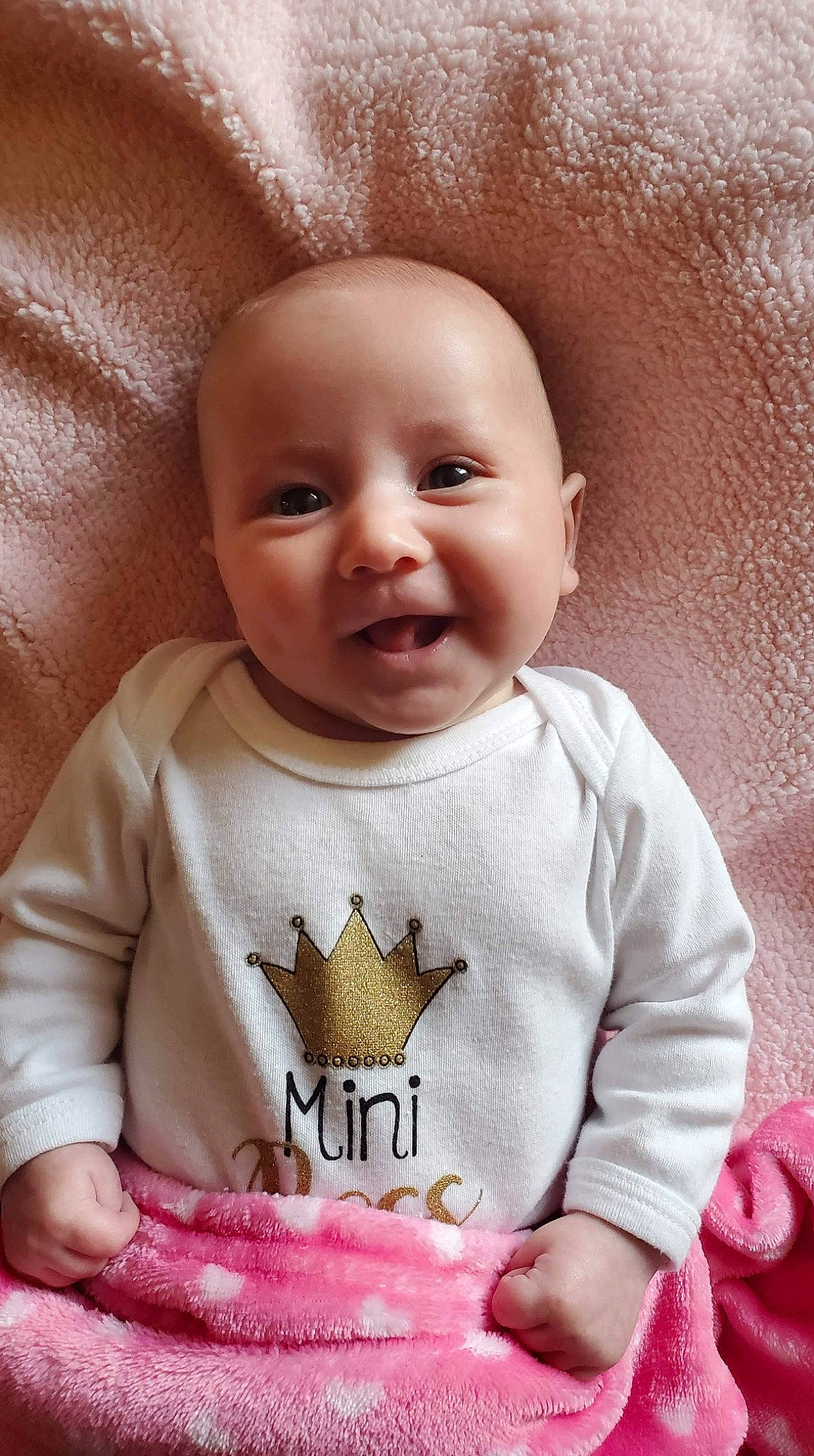 September is registered to the contest to win money with this photo: arm, baby_toddler_clothing, cheek, chin, clothing, dress, eye, eyebrow, head, iris, lip, mouth, neck, nose, outerwear, person, skin, sleeve, smile, textile