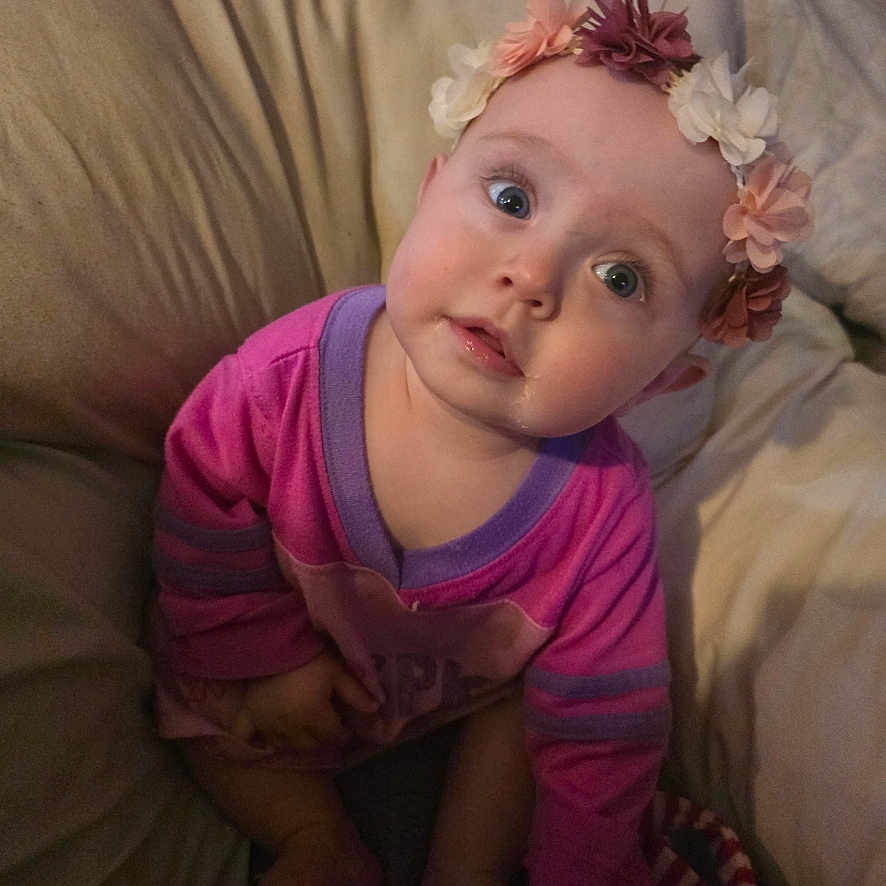 Harper is registered to the contest to win money with this photo: accessories, baby, bed, bodypart, cap, clothing, couch, cushion, face, finger, furniture, hand, hat, head, homedecor, indoors, newborn, person, photography, portrait