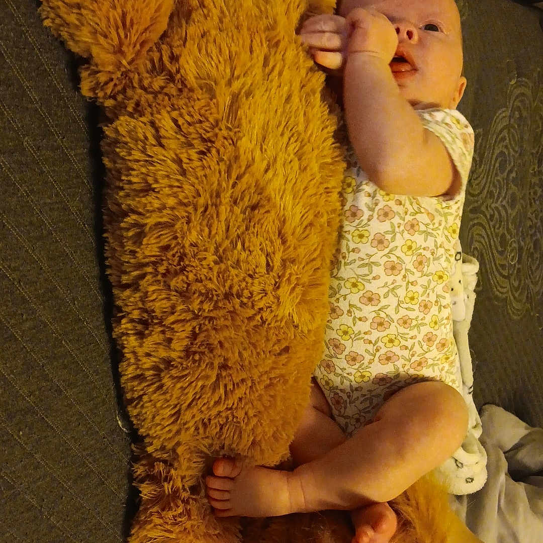 Embyrlea is registered to the contest to win money with this photo: baby, bed, blanket, child, cozy, cute, floral_onesie, foot, hand, human, indoor, infant, lying_down, person, plush_toy, relaxing, sleepwear, small, soft_toy, stuffed_animal