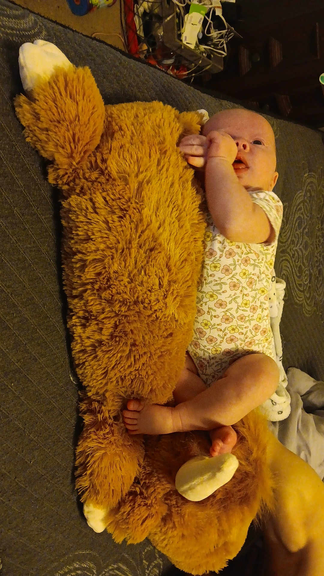 Embyrlea is registered to the contest to win money with this photo: baby, bed, blanket, child, cozy, cute, floral_onesie, foot, hand, human, indoor, infant, lying_down, person, plush_toy, relaxing, sleepwear, small, soft_toy, stuffed_animal