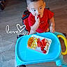 baby, child, curious, cute, eating, face, floor, food, happy, home, indoor, plate, play, red_shirt, snack, table, toddler, toy, walker, young_child