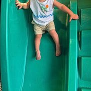 Carinlefty joined the competition — help win amazing prizes! child, toddler, slide, playground, smiling, happy, outdoor, plastic_slide, clothing, shorts, tank_top, barefoot, fun, play, green, yellow, stairs, person, joy, leisure