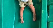Carinlefty joined the competition — help win amazing prizes! child, toddler, slide, playground, smiling, happy, outdoor, green_slide, yellow_play_structure, barefoot, casual_clothing, fun, joy, summer, play, active, person, plastic_slide, climbing_structure, cute