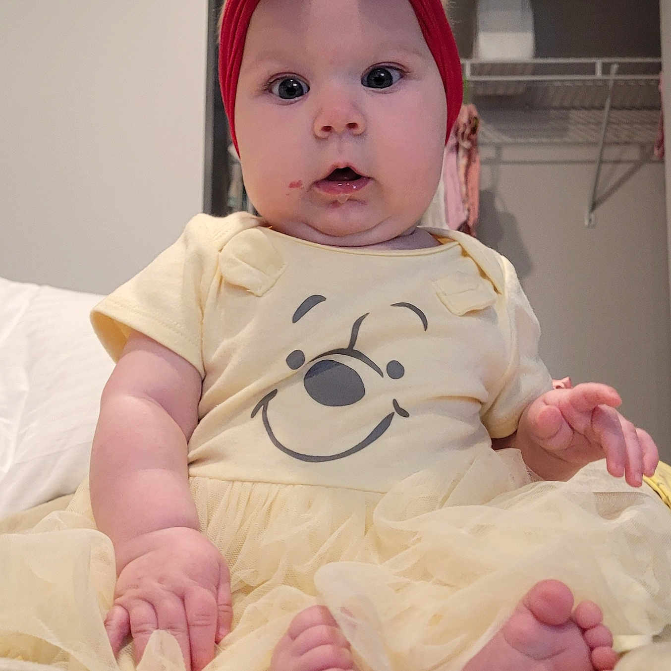 Saphire is registered to the contest to win money with this photo: baby, bed, bedroom, bodypart, bonnet, clothing, couch, face, finger, furniture, hand, hat, head, indoors, newborn, person, photography, portrait, room, sitting