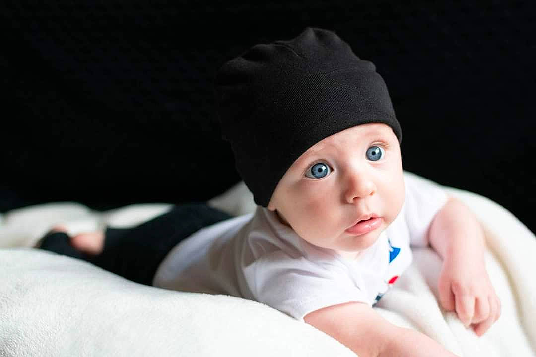 Matthew is registered to the contest to win money with this photo: baby, beanie, cap, child, eye, finger, hand, headgear, headwear, person, photography, portrait_photography, skin, toddler