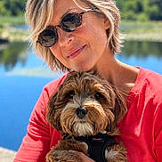 Dominique Geneste a rejoint le concours — aidez-le/la à gagner de superbes lots ! brown_fur, closeup, cuddle, dog, fluffy, happy, harness, holding, lake, nature, outdoors, pet, portrait, red_shirt, scenic, small_dog, sunglasses, sunlight, water, woman