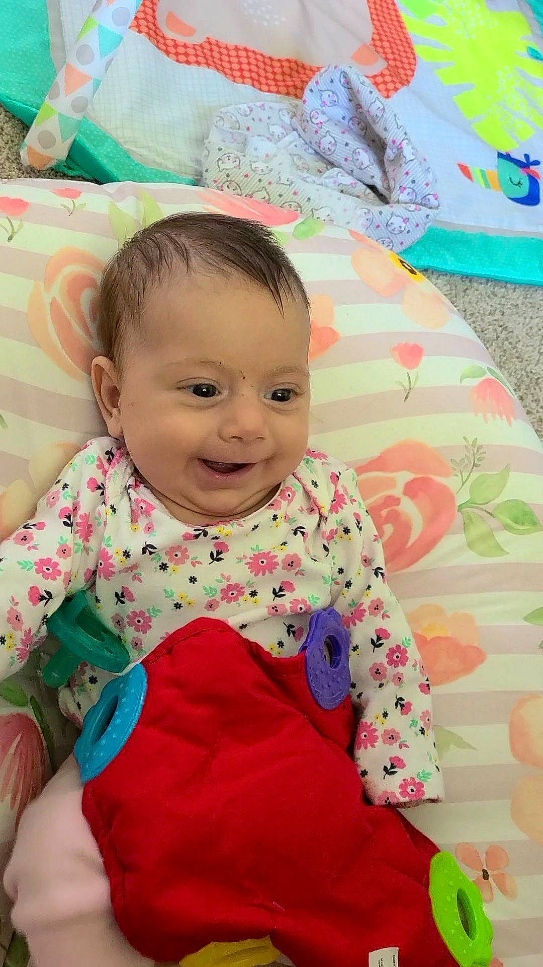 Gabriella is registered to the contest to win money with this photo: baby, baby_toddler_clothing, beauty, cheek, child, clothing, comfort, eye, face, happy, head, linens, pattern, person, pink, product, skin, sleeve, smile, textile