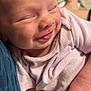 baby, infant, smiling, face, close_up, person, hand, clothing, skin, newborn, cute, happy, sleepy, portrait, holding, soft, toddler, child, warmth, comfort