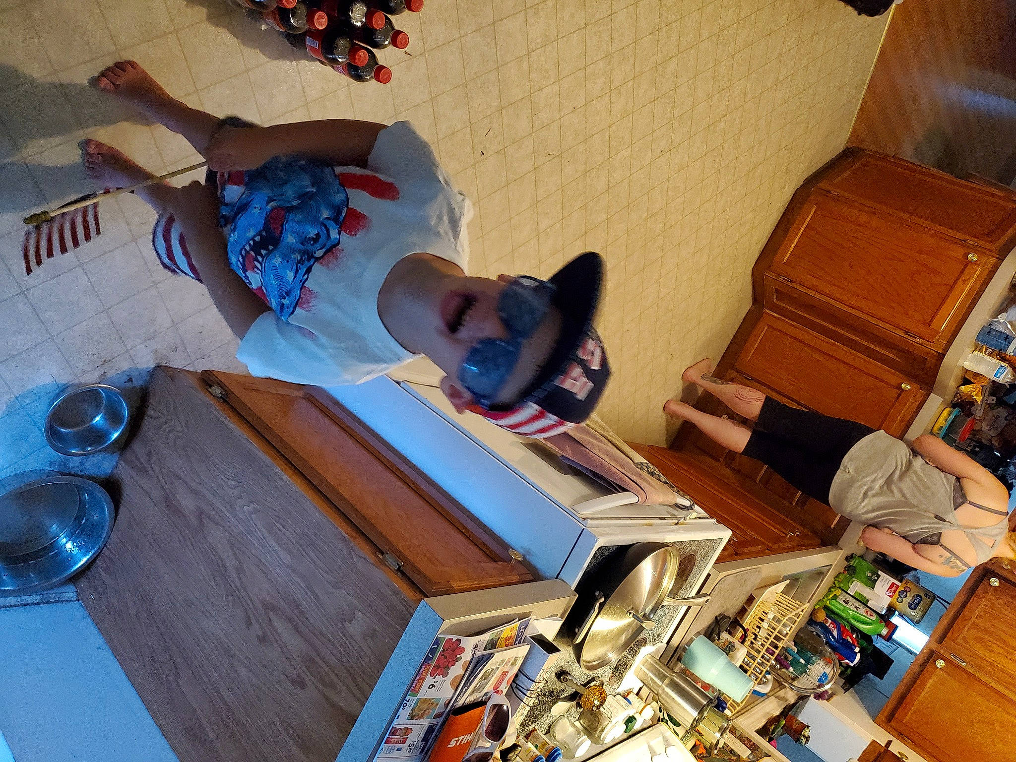 Kian is registered to the contest to win money with this photo: canidae, carnivore, companion_dog, dog, fawn, floor, flooring, french_bulldog, furniture, headwear, miniature_pinscher, non_sporting_group, person, room, table, wood