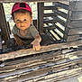 toddler, child, beach, sand, wood, wooden_structure, hat, cap, polka_dot, sunlight, shadow, outdoor, curious, face, hand, clothing, play, summer, vacation, nature