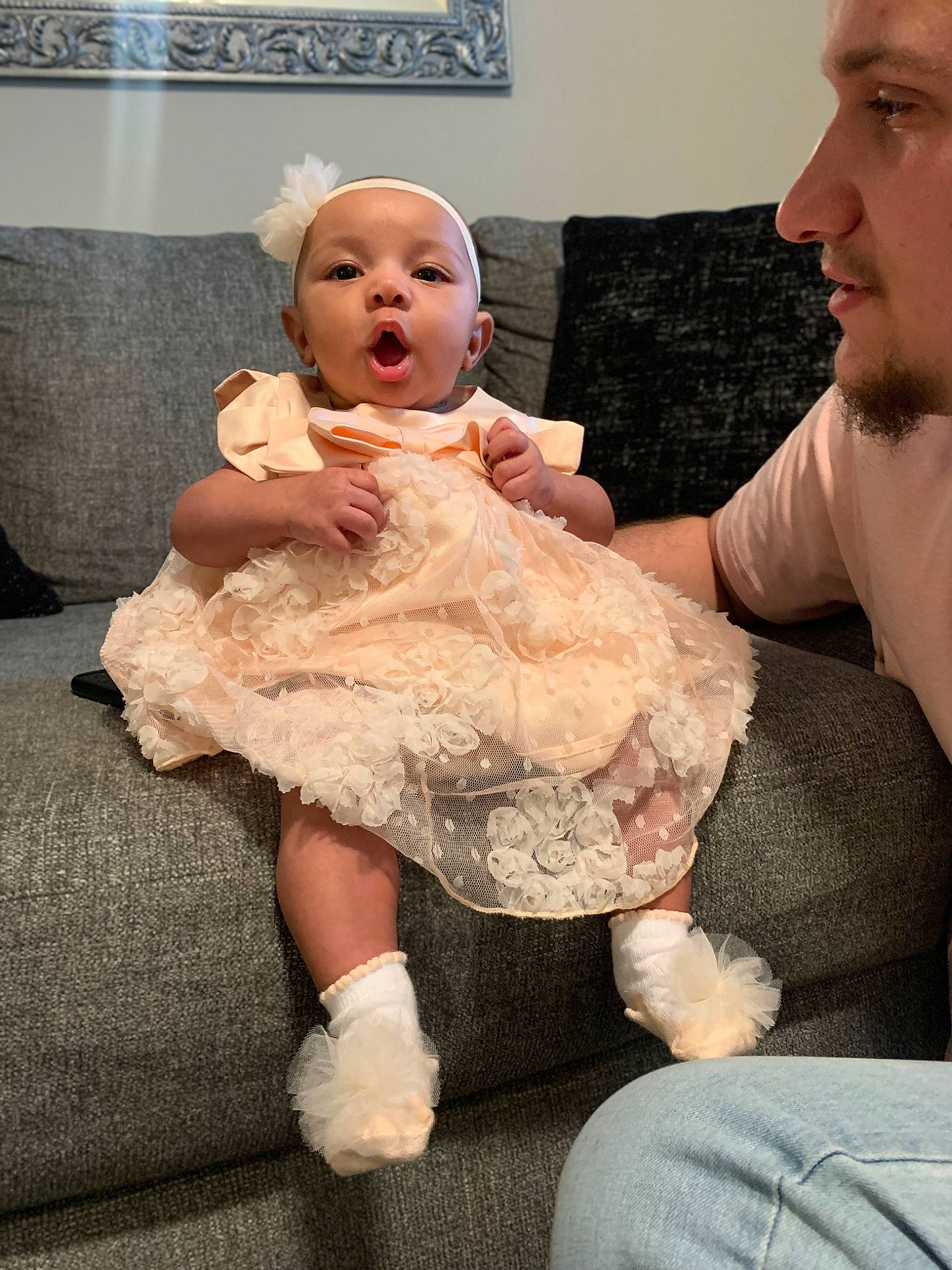 Zhavia is registered to the contest to win money with this photo: baby, baby_toddler_clothing, cheek, comfort, couch, dress, event, face, finger, flash_photography, fun, gesture, happy, head, human_body, iris, lap, person, skin, toddler