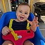 Santiago joined the competition — help win amazing prizes! baby, swing, smile, child, outdoor, playground, yellow_straps, blue_swing, red_toy, happy, face, teeth, hand, grill, backyard, clothing, person, daylight, expression, fun