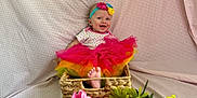 Sage joined the competition — help win amazing prizes! baby, basket, tutu, headband, flowers, pink, yellow, green, smiling, happy, infant, colorful, clothing, fabric, background, foot, cute, sitting, person, portrait