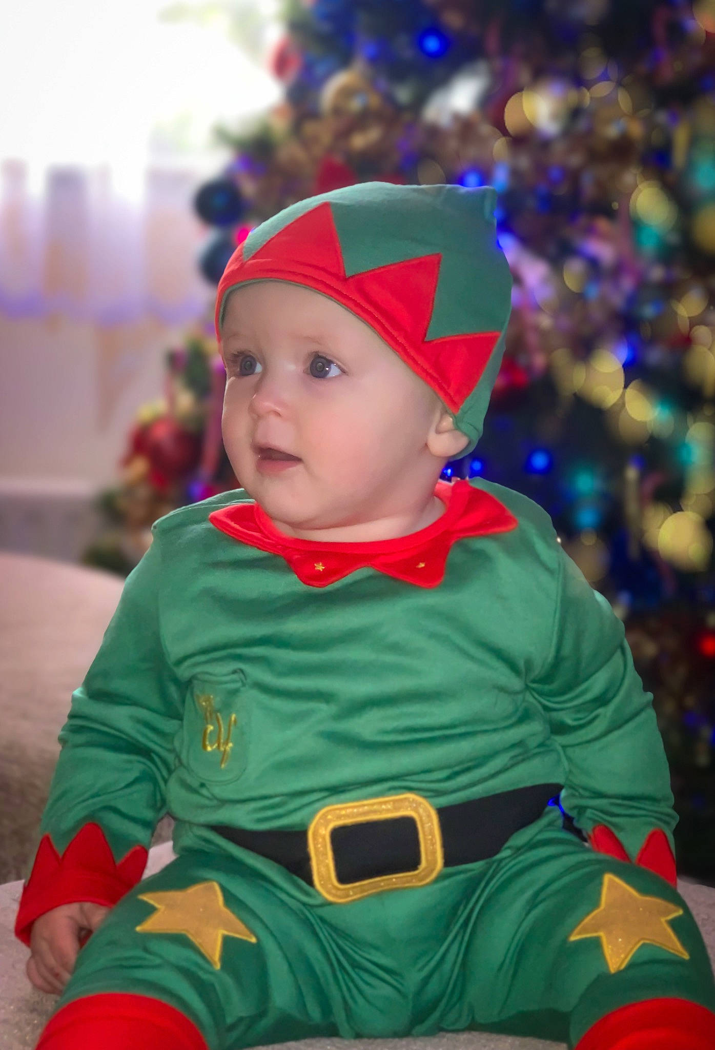 Izabella joined the competition — help win amazing prizes! baby, child, christmas, christmas_decoration, christmas_eve, christmas_ornament, christmas_tree, costume_hat, event, face, facial_expression, fictional_character, fun, happy, headwear, holiday, person, purple, santa_claus, toddler