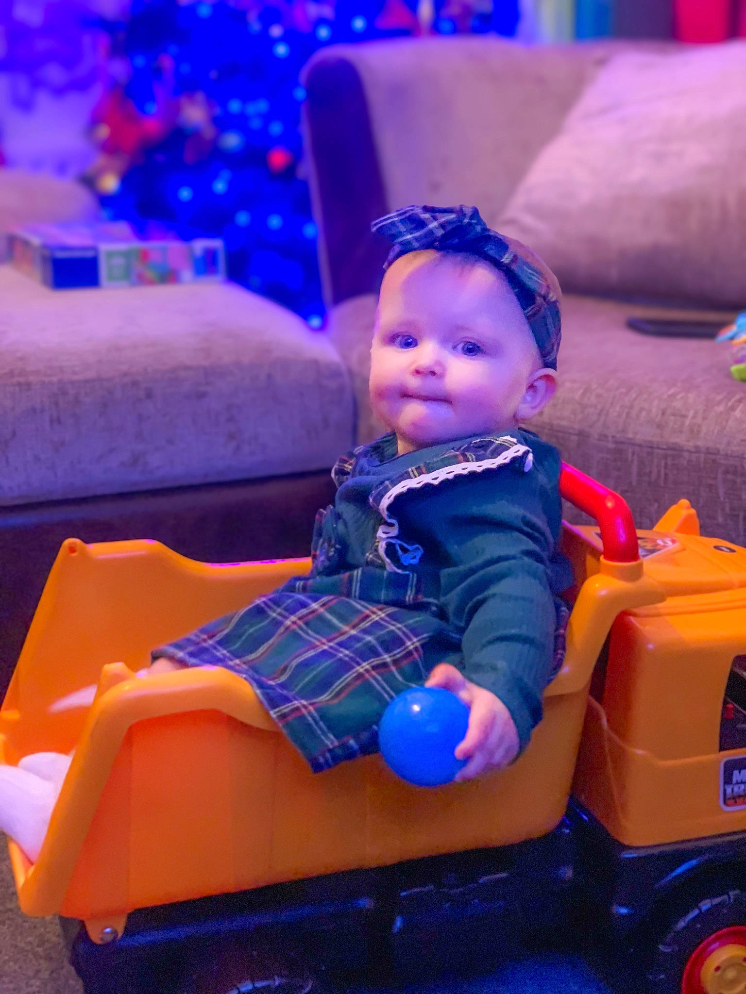 Izabella is registered to the contest to win money with this photo: automotive_design, baby, baby_toddler_clothing, blue, child, electric_blue, event, fun, leisure, magenta, motor_vehicle, person, plastic, purple, riding_toy, sitting, tire, toddler, toy, toy_vehicle