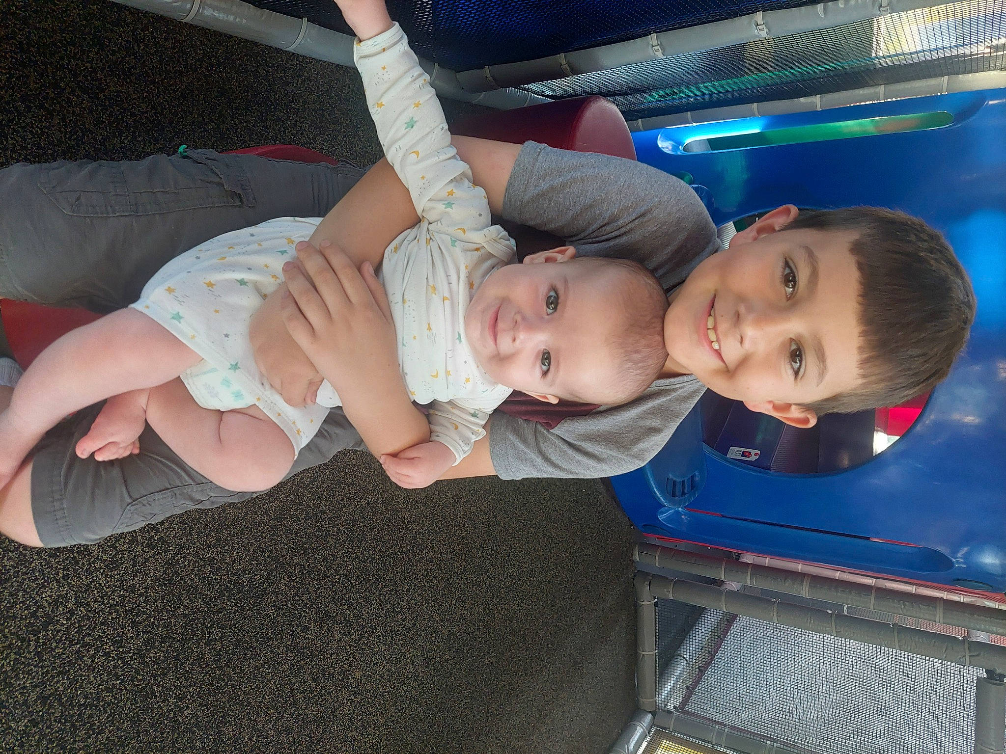 Waylon is registered to the contest to win money with this photo: baby, baby_products, baby_toddler_clothing, cheek, child, comfort, elbow, electric_blue, fun, human_leg, joy, knee, lap, mouth, person, sitting, skin, smile, sock, thigh