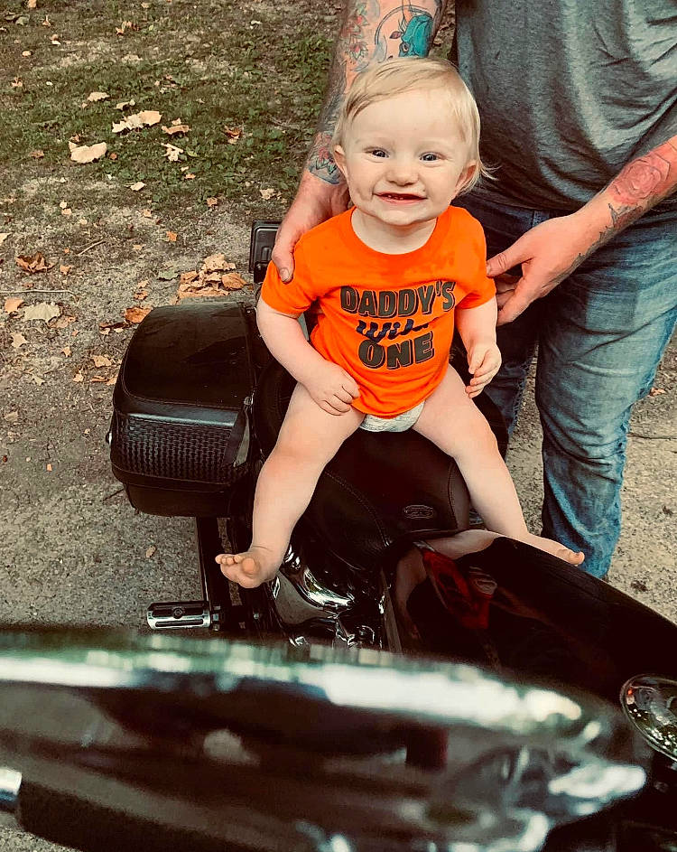 Jasper is registered to the contest to win money with this photo: automotive_exterior, automotive_tire, baby, baby_toddler_clothing, bumper, cool, eye, fun, grass, happy, head, hood, joy, leisure, motor_vehicle, person, photograph, pink, smile, snapshot