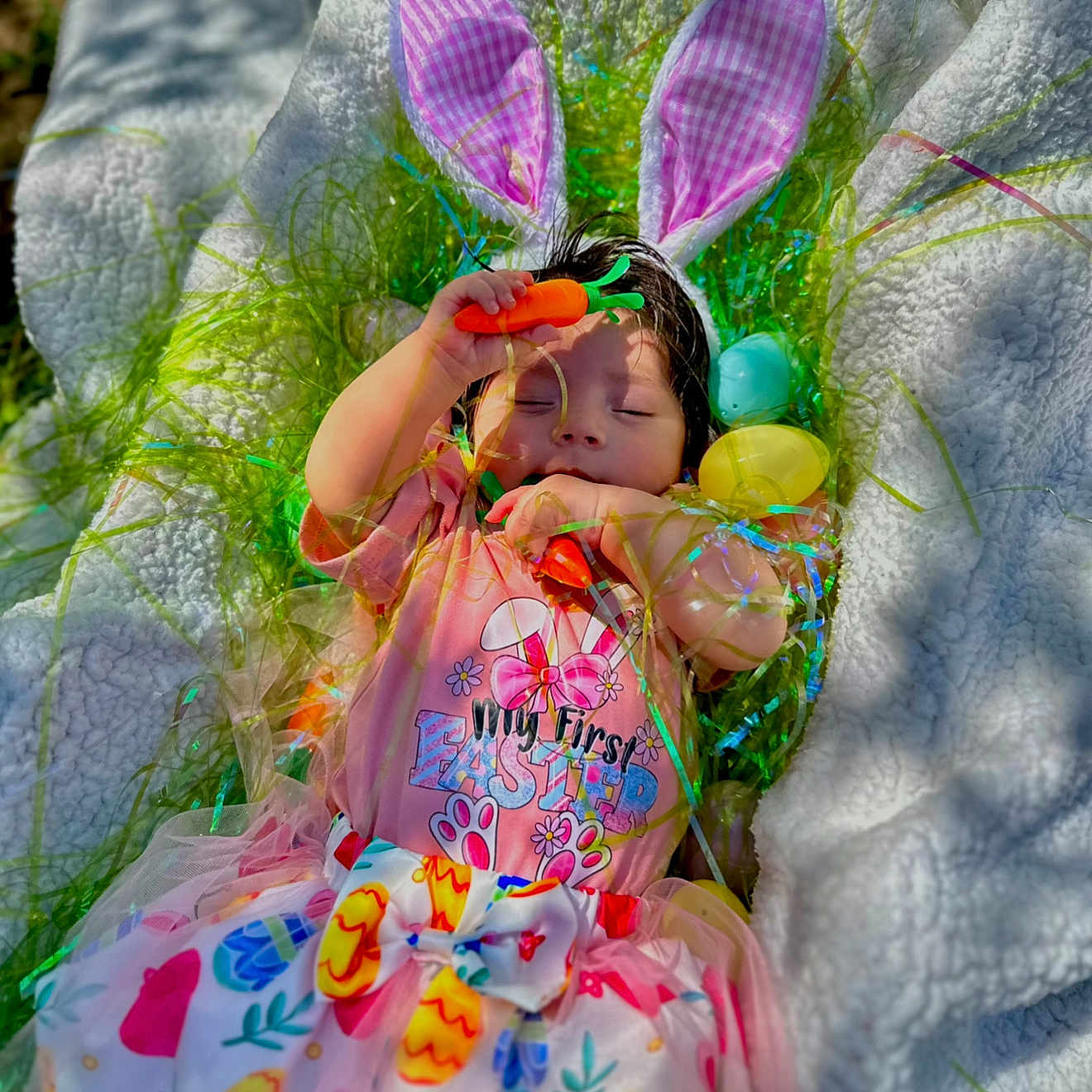 Malerie is registered to the contest to win money with this photo: baby, balloon, blanket, clothing, dress, face, flower, food, grass, hat, head, person, petal, photography, plant, portrait, purple, quilt, sweets, toy