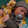 newborn, baby, sleeping, plush_toy, simba, pacifier, pacifier_clip, baby_clothes, hat, blanket, green_blanket, yellow_pattern, cute, infant, hand, face, peaceful, resting, child, soft_toy