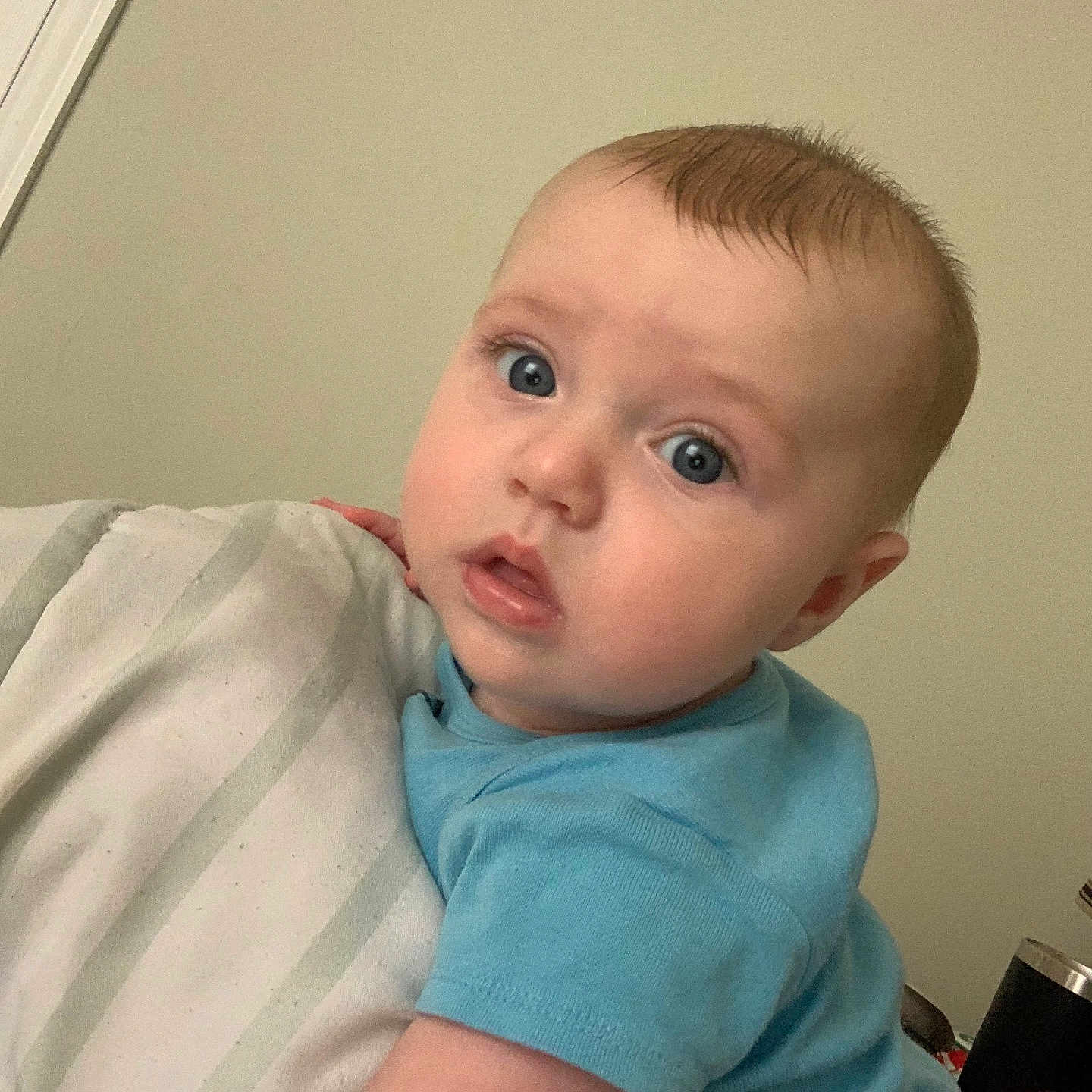 Mason is registered to the contest to win money with this photo: baby, bed, bedroom, bodypart, clothing, face, finger, furniture, hand, head, indoors, newborn, pants, person, photography, portrait, room, selfie, shirt, t_shirt