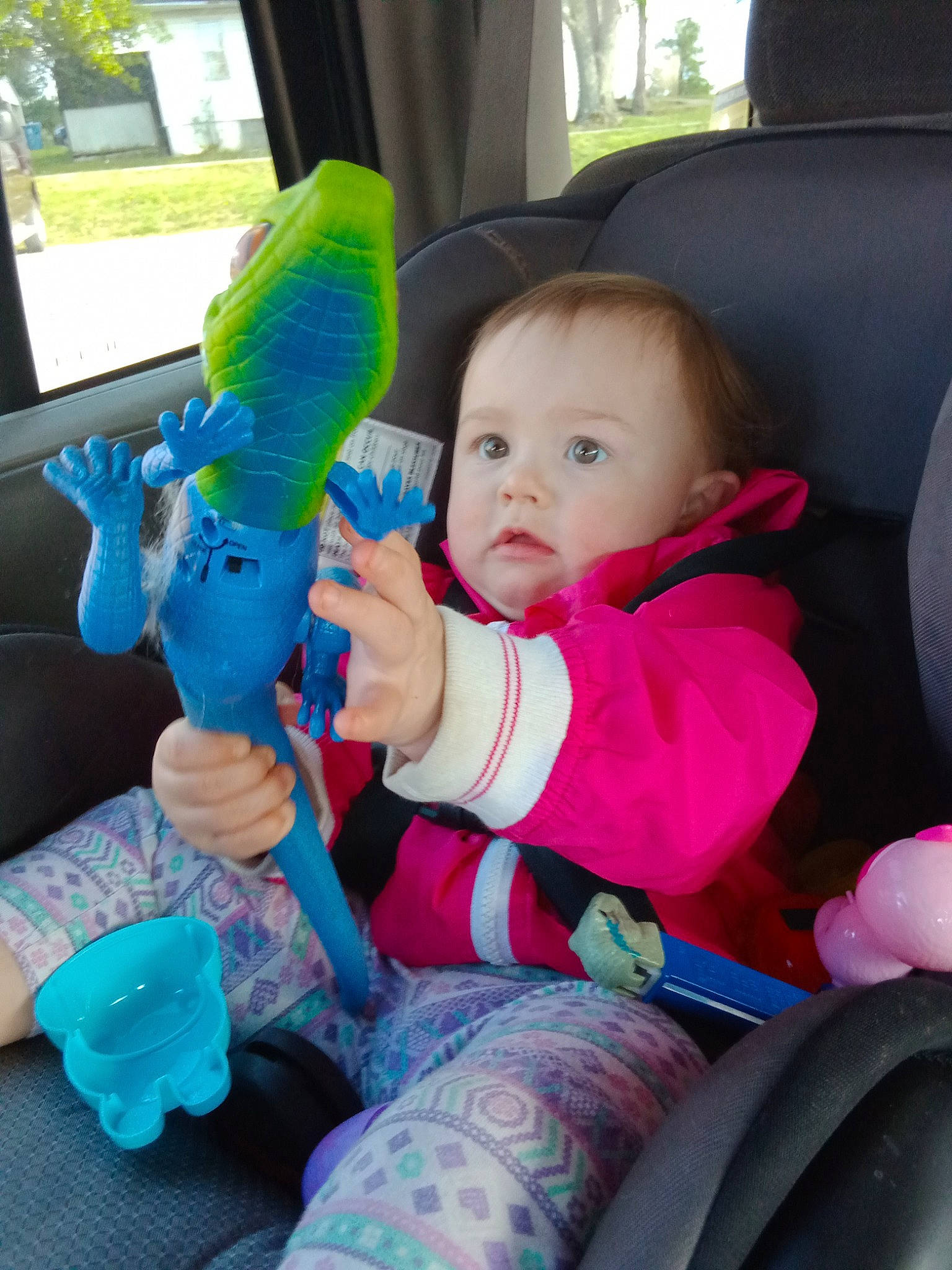 Lorraine is registered to the contest to win money with this photo: baby, baby_products, baby_toddler_clothing, car_seat, car_seat_cover, child, comfort, electric_blue, fun, lap, macaw, parrot, person, pink, product, sitting, stuffed_toy, toddler, toy, vacation