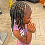 beads, braided_hair, casual_wear, caution_sign, child, colorful_clothing, curious, floor_tiles, flooring, hair_style, indoor, person, pink_pants, portrait, restaurant, sandals, side_view, sleeveless_top, standing, young