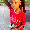 Tesean is registered to the contest to win money with this photo: child, boy, toy, red_shirt, jeans, outdoor, pavement, grass, jacket, portrait, standing, casual_clothing, daylight, curious, black_shoes, short_hair, looking_at_camera, sidewalk, play, person