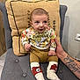 Livio a rejoint le concours — aidez-le/la à gagner de superbes lots ! baby, infant, child, sitting, chair, cushion, pillow, clothing, socks, face, hand, tattoo, indoor, floor, wood, wall, cute, curious, portrait, smiling