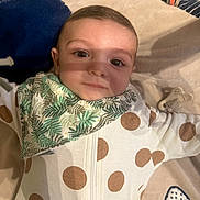 Livio participe au concours pour gagner de l'argent avec cette photo : baby, infant, child, face, eyes, blanket, bib, pacifier, polka_dot, sleeper, clothing, lying_down, portrait, indoor, tiled_floor, gaze, shadow_on_face, cheek, forehead, play_mat