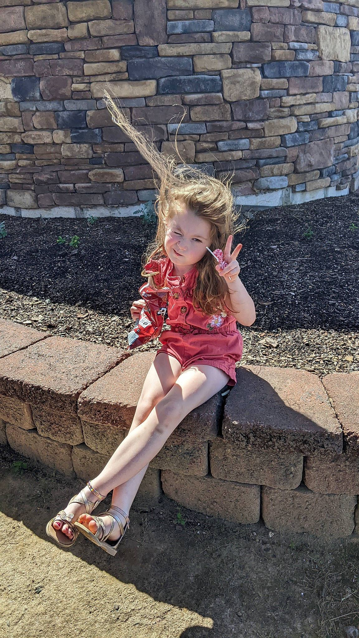 Raleigh is registered to the contest to win money with this photo: blond, boot, brick, brickwork, brown_hair, costume, denim, eyewear, fashion_accessory, grass, happy, human_leg, knee, leisure, long_hair, pattern, person, sandal, sitting, thigh