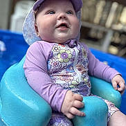 Teagyn joined the competition — help win amazing prizes! baby, blue_seat, child, closeup, cute, daylight, floral_pattern, happy, hat, infant, outdoor, pool, seat, sitting, smiling, summer, sun_hat, swimsuit, water, water_droplets