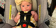 Teagyn joined the competition — help win amazing prizes! baby, blanket, bow, car_seat, child, clothing, cushion, cute, fabric, face, feet, indoors, infant, legs, person, safety_harness, seat, soft_lighting, straps, yellow_bow