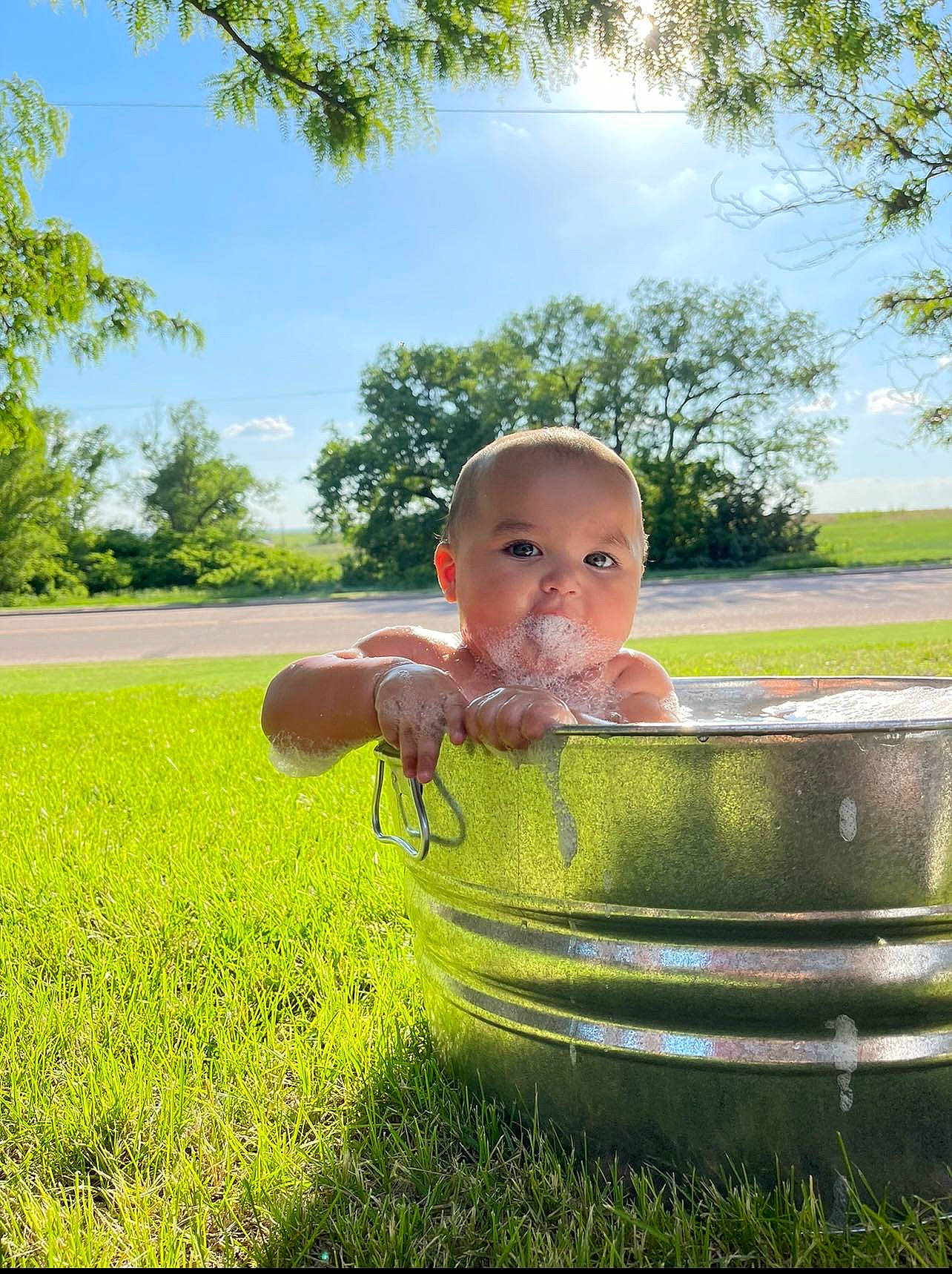 Massiah is registered to the contest to win money with this photo: baby, fun, grass, grass_family, grassland, green, groundcover, happy, landscape, lawn, leisure, meadow, people_in_nature, person, plant, recreation, sitting, sky, sunlight, toddler