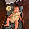 baby, infant, basket, cushion, wood_floor, indoor, child, cute, sitting, clothing, flooring, home, person, face, skin, legs, hands, expression, furniture, soft