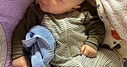 Amoni joined the competition — help win amazing prizes! baby, sleeping, infant, bottle, blanket, towel, clothing, striped_onesie, purple, yellow_star, peaceful, cute, hand, face, head, indoors, soft_texture, comfort, resting, newborn