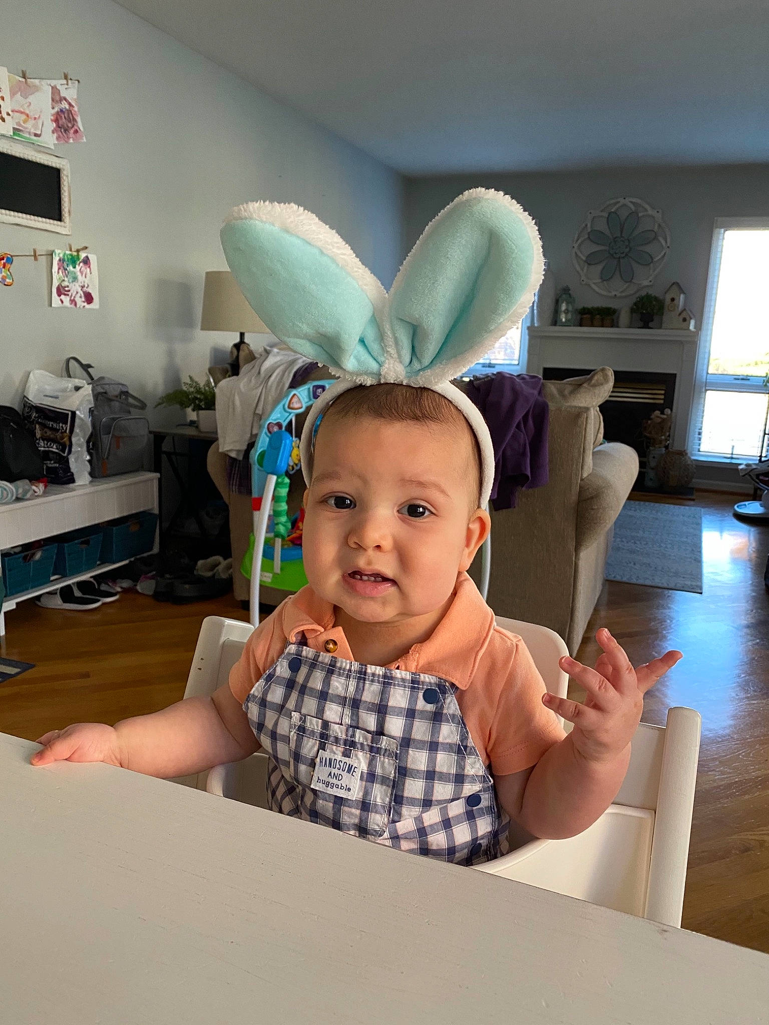 Konnor is registered to the contest to win money with this photo: baby, child, comfort, desk, fashion_accessory, flooring, fun, happy, hat, headgear, linens, party_supply, person, play, room, selfie, sitting, t_shirt, table, tableware