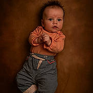 Kaïna a rejoint le concours — aidez-le/la à gagner de superbes lots ! baby, infant, child, portrait, clothing, pants, shoes, cute, expression, face, hair, background, laying, looking, curious, small_hands, footwear, soft_lighting, studio, casual