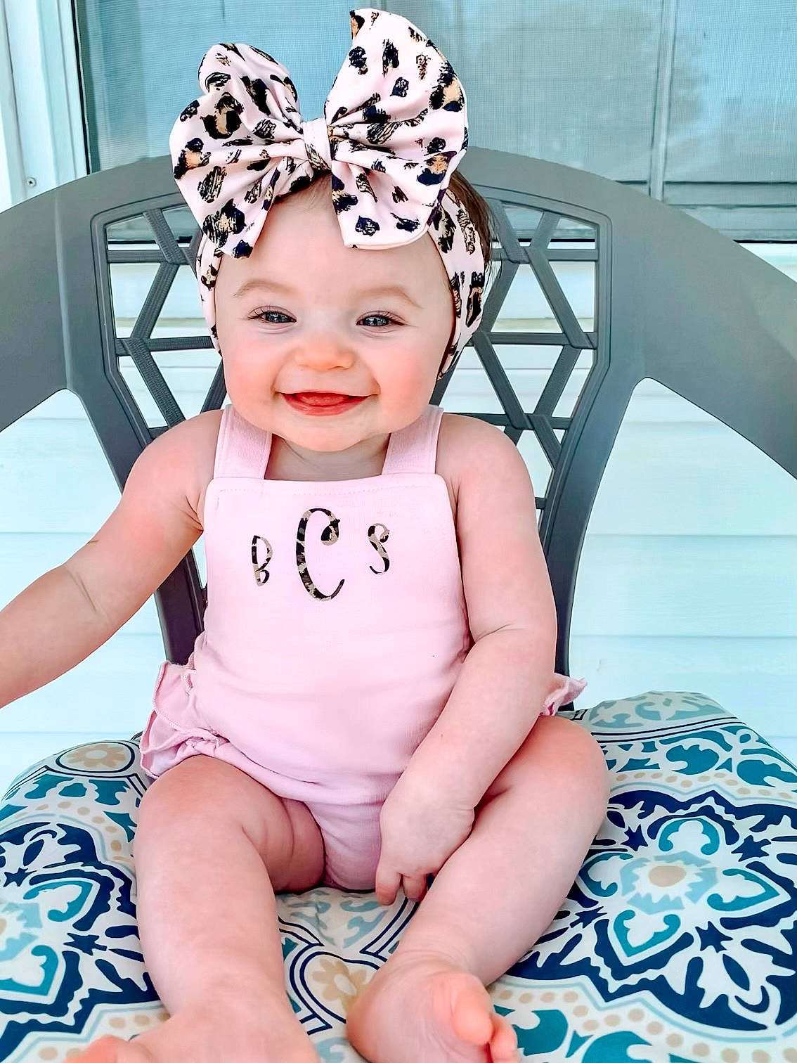 Baylor is registered to the contest to win money with this photo: baby, baby_toddler_clothing, blue, cap, child, eye, fashion_accessory, fun, happy, head, headband, headpiece, headwear, joy, pattern, person, pink, skin, sleeve, smile