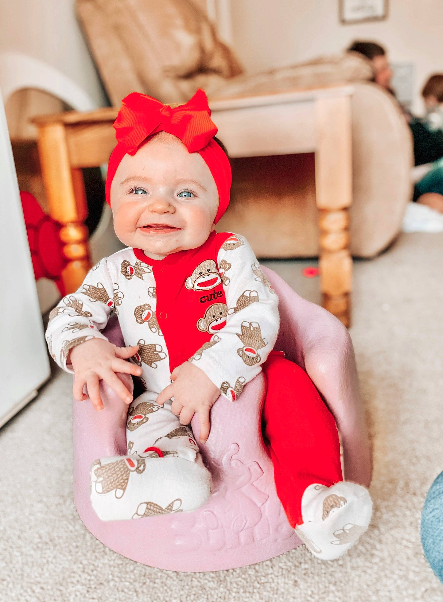 Baylor is registered to the contest to win money with this photo: baby, baby_products, baby_toddler_clothing, cap, carmine, child, christmas, christmas_eve, costume_hat, event, fashion_accessory, fictional_character, fun, happy, headwear, holiday, joy, person, pink, sitting