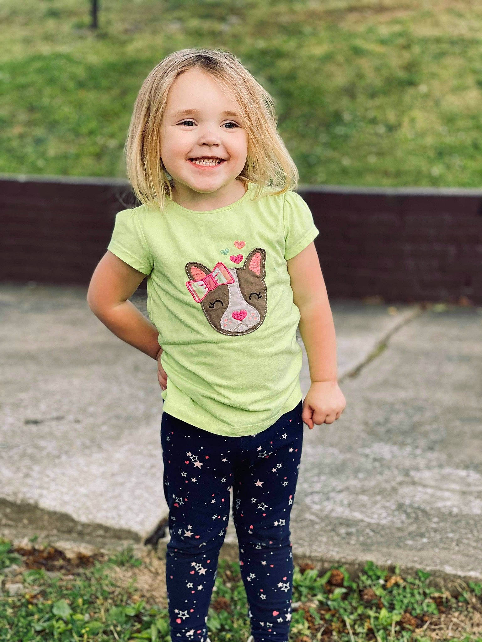 Waverly is registered to the contest to win money with this photo: arm, clothing, face, grass, hair, happy, joy, knee, leg, leisure, long_hair, neck, people_in_nature, person, sleeve, smile, street_fashion, summer, t_shirt, thigh