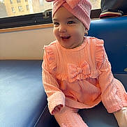 Mia Dayance joined the competition — help win amazing prizes! baby, pink_outfit, headwrap, bow, smiling, sitting, couch, window, sunlight, earrings, indoor, child, happy, knitwear, cute, portrait, infant, fashion, cozy, soft_lighting