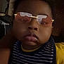 Kevion joined the competition — help win amazing prizes! baby, child, face, glasses, sunglasses, striped_clothing, yellow_clothing, indoor, portrait, closeup, young_child, person, dark_background, reflection, head, expressionless, casual, fashion, toddler, cute