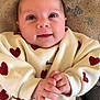 baby, infant, smiling, face, hands, sweater, hearts, towel, fish_pattern, baby_seat, chicco, clothing, cute, portrait, child, indoor, closeup, happy, person, soft_texture
