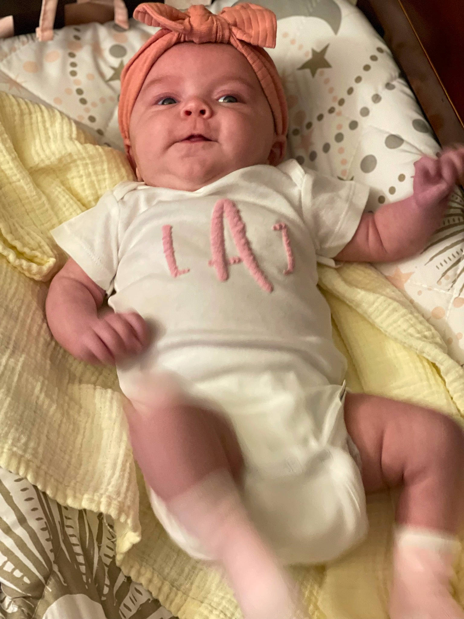 Liana is registered to the contest to win money with this photo: baby, baby_products, baby_safety, baby_sleeping, baby_toddler_clothing, bedding, bedtime, cheek, child, comfort, eye, head, linens, person, pink, room, sitting, skin, sleeve, textile