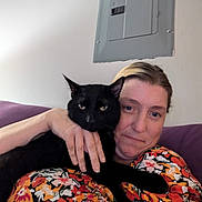 Onyx joined the competition — help win amazing prizes! adult, animal, blackcat, bodypart, cat, couch, cushion, face, female, finger, furniture, hand, head, homedecor, indoors, kitten, manx, person, pet, woman